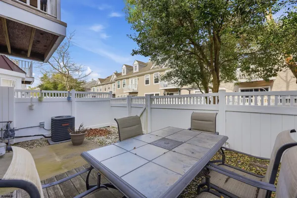 a view of a patio with table and chairs and potted plants