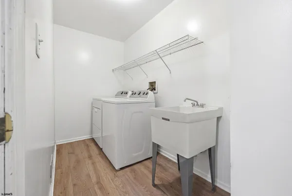 a utility room with cabinets washer and dryer