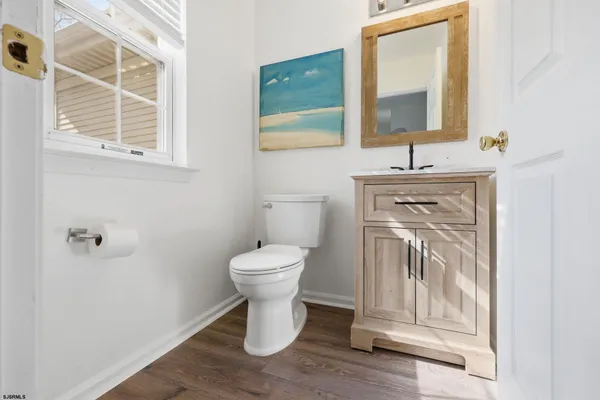 a bathroom with a toilet a sink and mirror