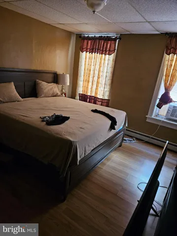 a bedroom with a bed and window