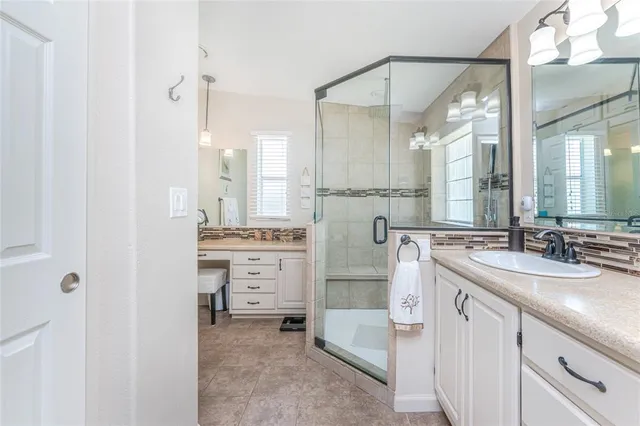 a bathroom with a double vanity sink mirror and