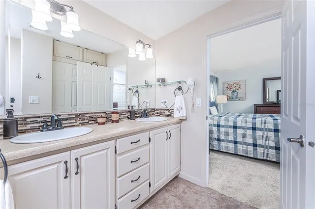 a bathroom with double sink and a mirror