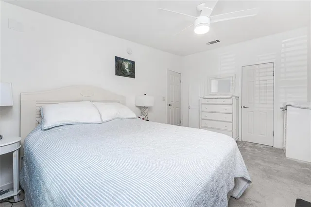 a bedroom with a bed and a closet