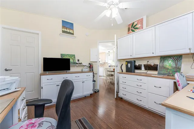 a kitchen with cabinets stainless steel appliances and a dining table