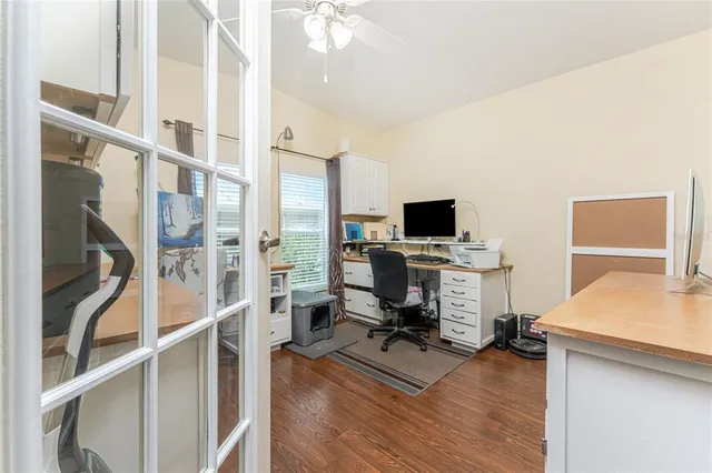 a view of a workspace with furniture and a flat screen tv