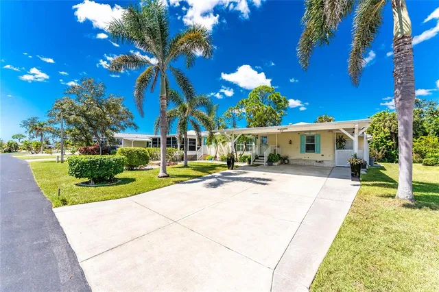 a view of a house with sitting area and a yard