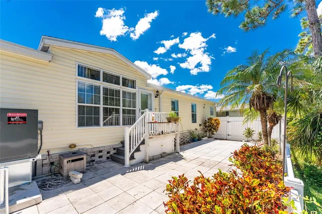 a view of a house with backyard porch and sitting area