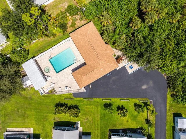 an aerial view of a house with garden space and a street view