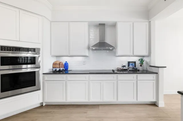 a kitchen with white cabinets and a sink