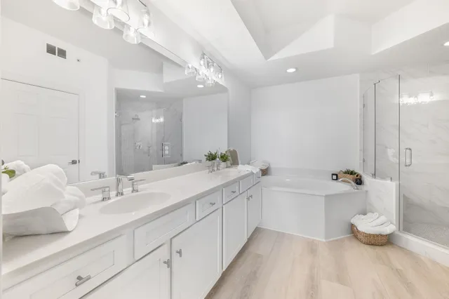 a bathroom with a sink mirror toilet and shower