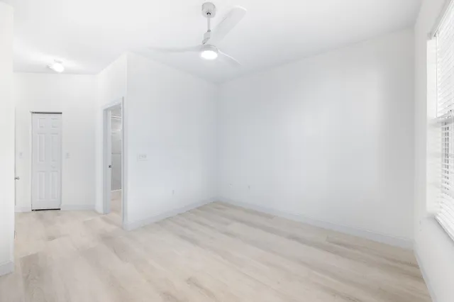 a view of empty room with floor to ceiling window and an empty room
