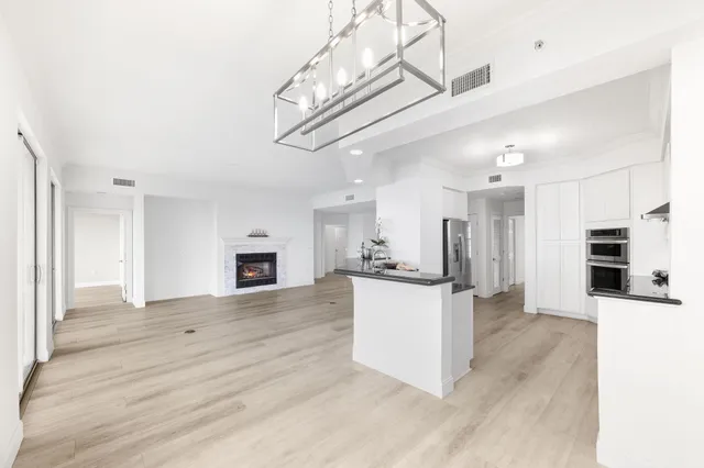 a living room with a fireplace and a wooden floor