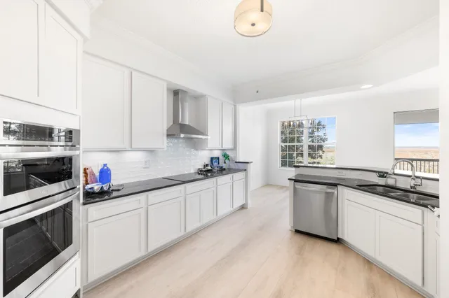 a kitchen with a sink stove and window