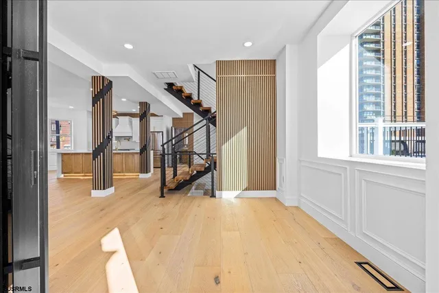 a view of a livingroom with wooden floor and a ceiling fan