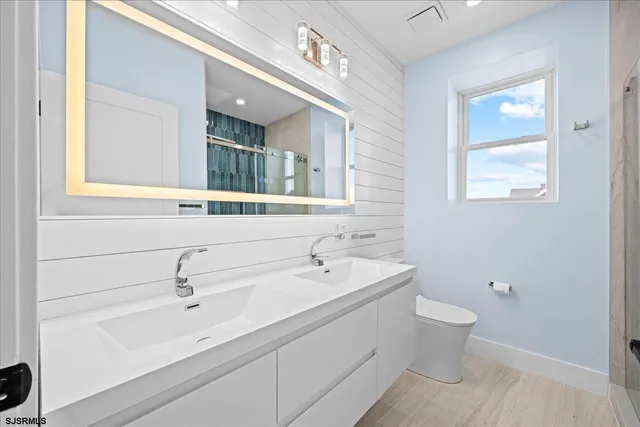 an empty room with windows and ceiling fan