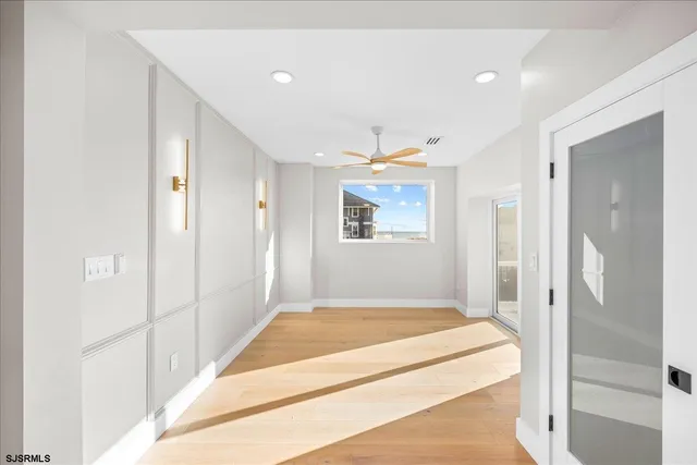 a view of an empty room with wooden floor