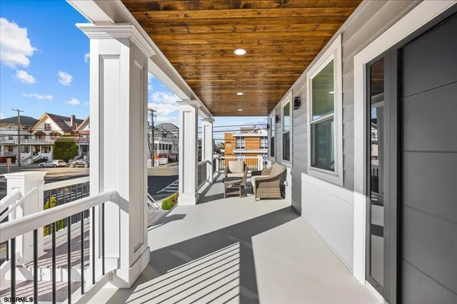 a balcony with furniture and a potted plant