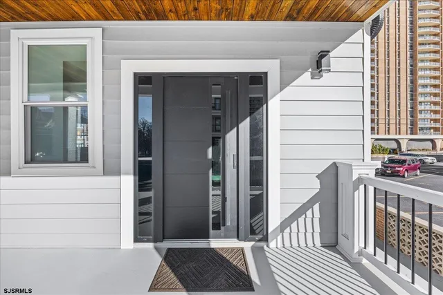 a living room with furniture and a floor to ceiling window