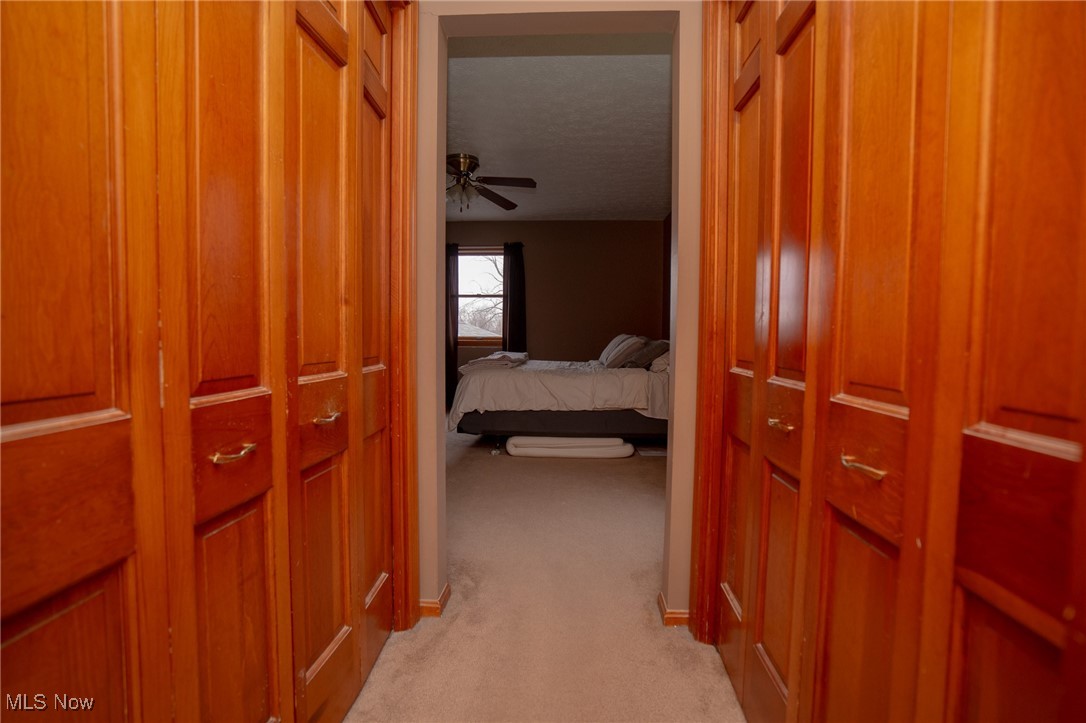 8651 King Graves Road Northeast Warren, OH 44484 - Photo 18 of 24 Corridor featuring light carpet and a textured ceiling