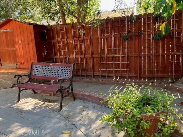 9656 Green Verdugo Drive Shadow Hills, CA 91040 - Photo 34 of 54 a view of a backyard with chairs and a black umbrella