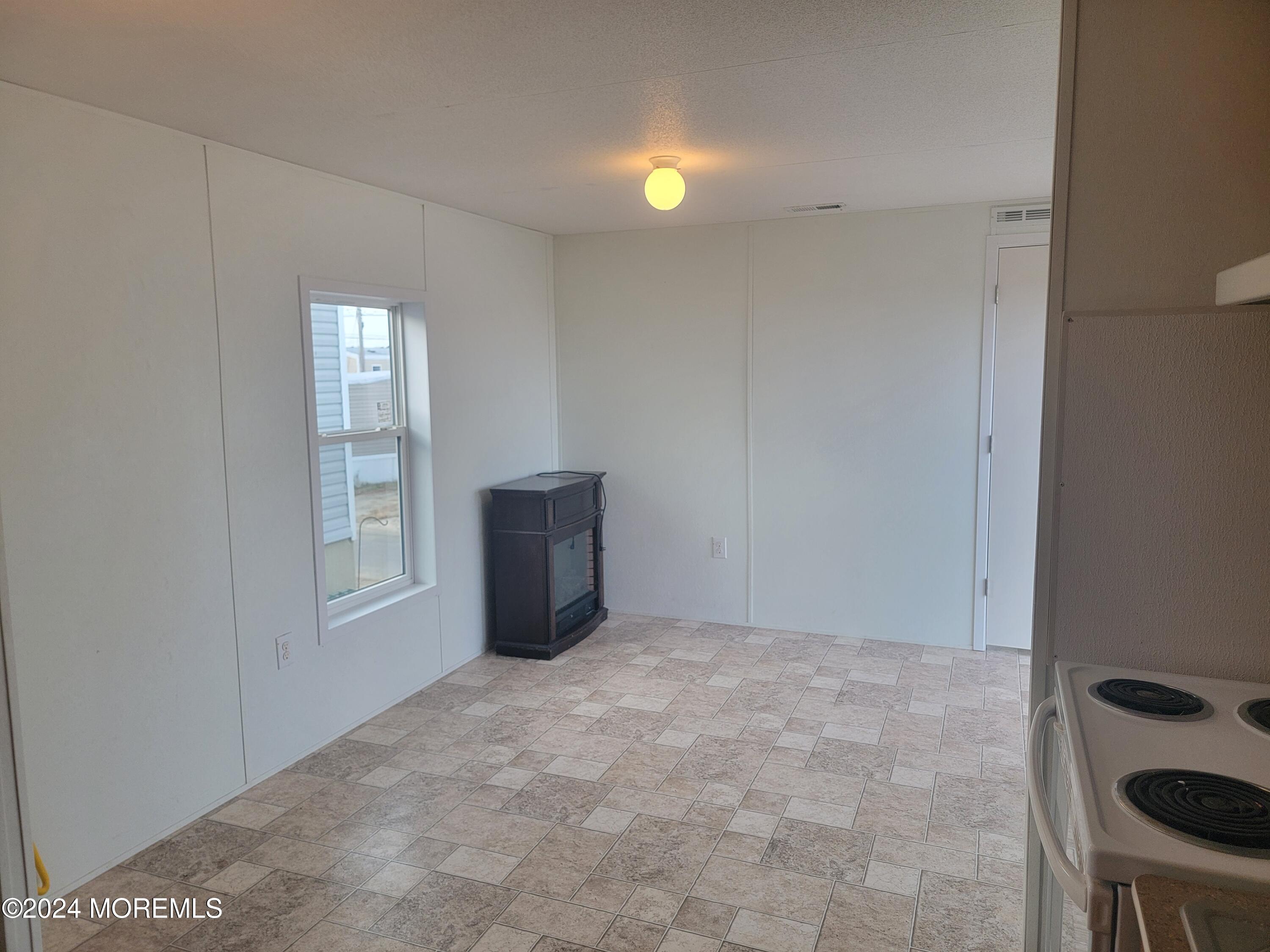 469 South Green Street, Unit 7 Tuckerton, NJ 08087 - Photo 5 of 11 a view of an empty room with a window