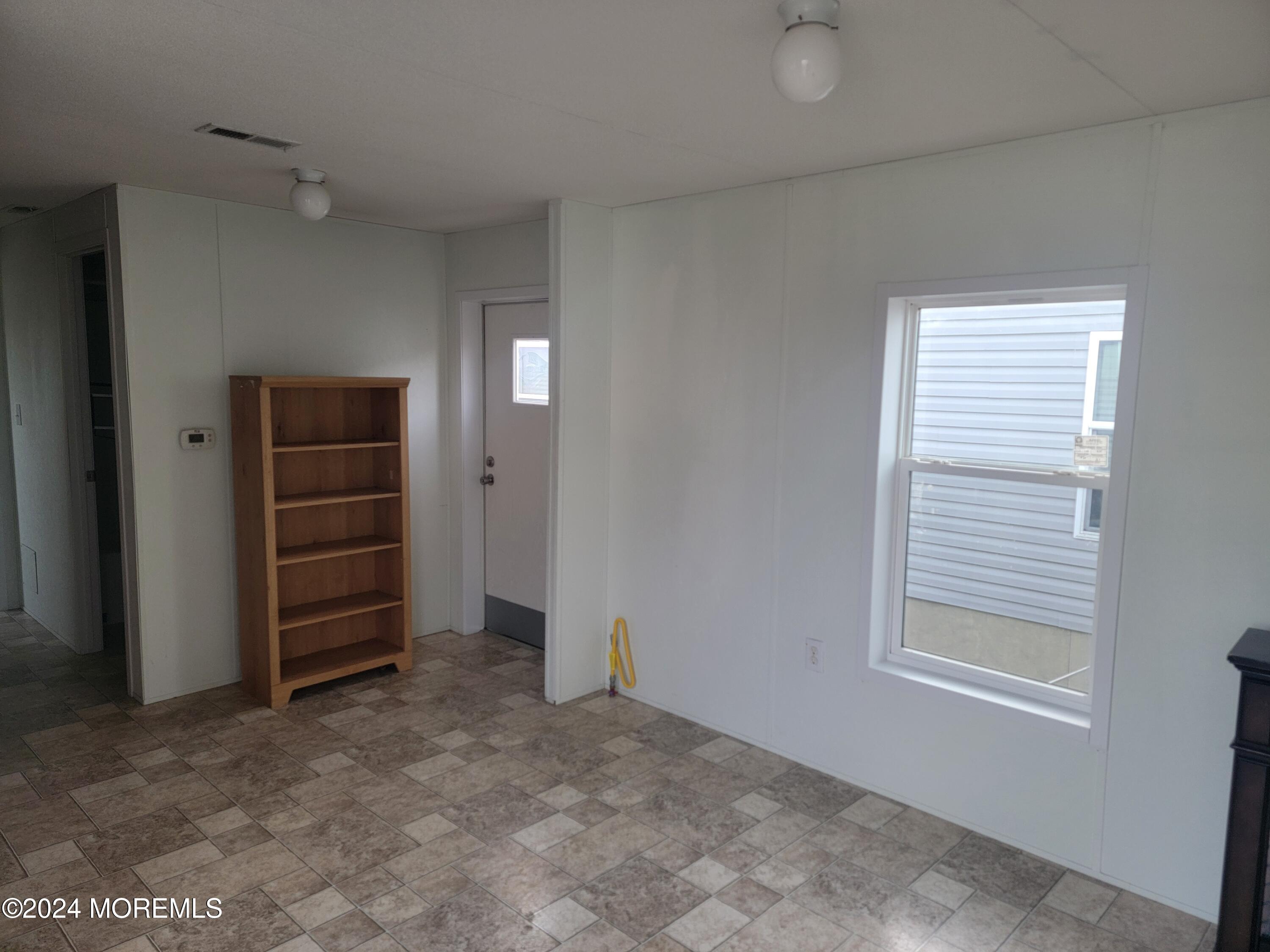 469 South Green Street, Unit 7 Tuckerton, NJ 08087 - Photo 6 of 11 a view of an empty room with a cabinet and a window