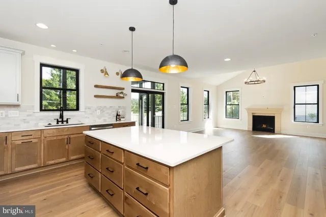 a kitchen with sink cabinets and wooden floor