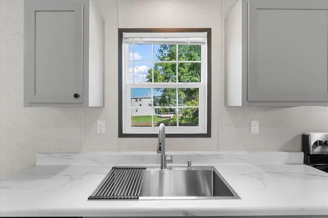 a kitchen that has a sink and a window