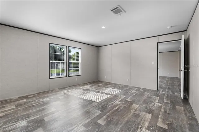 an empty room with windows and closet