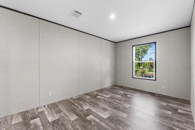 a view of room with window and hardwood floor
