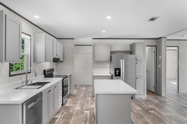a kitchen with a sink stove and refrigerator