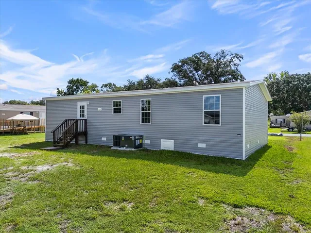 a view of a house with a backyard