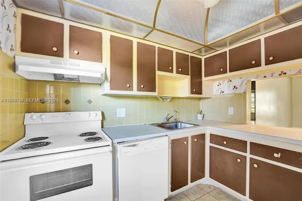 a kitchen with stainless steel appliances a stove a refrigerator and a sink