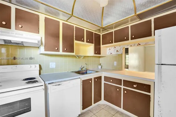 a kitchen with stainless steel appliances a sink and a refrigerator