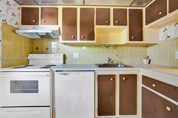 a kitchen with a refrigerator and a sink