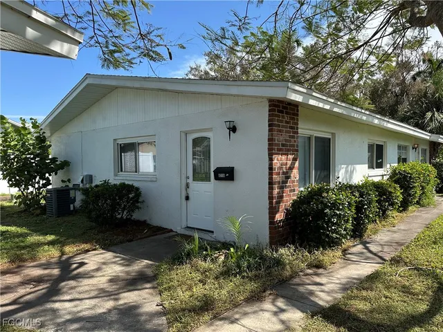 a house with a flower garden in front of it