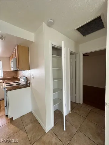 a kitchen with stainless steel appliances granite countertop a refrigerator and a stove