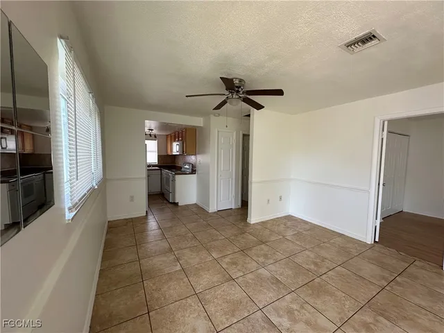 a view of a kitchen with a sink and a refrigerator