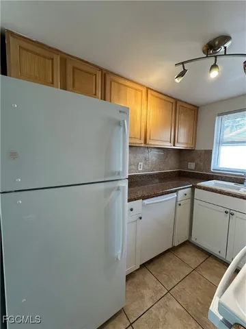 a kitchen with a refrigerator and a sink