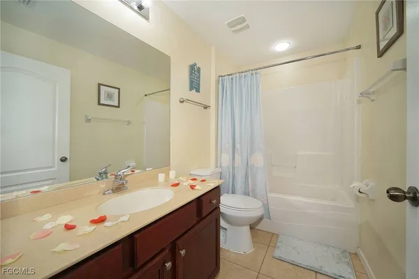 a bathroom with a double vanity sink toilet and shower
