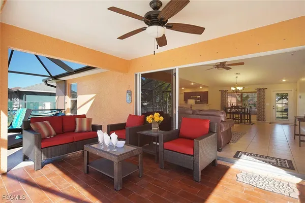 a living room with furniture and a ceiling fan