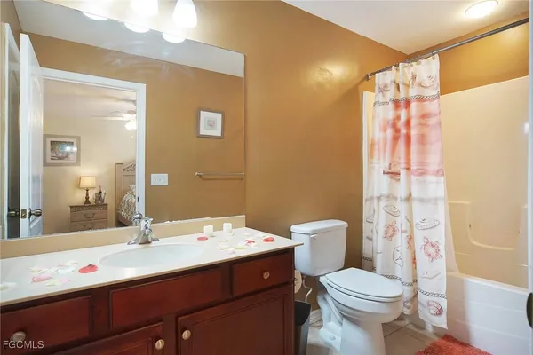 a bathroom with a sink a toilet a shower and a mirror