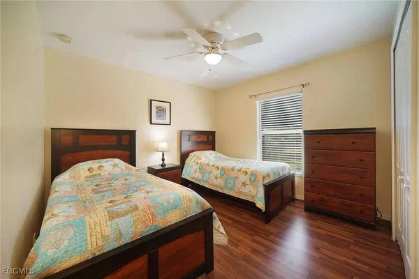 a bedroom with two beds and painting on the wall