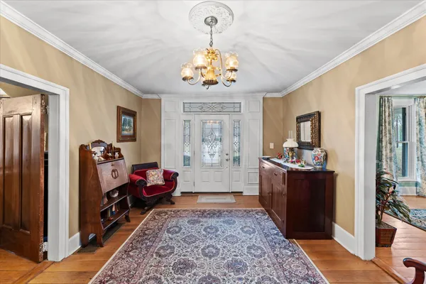 a kitchen that has a lot of cabinets and wooden floor