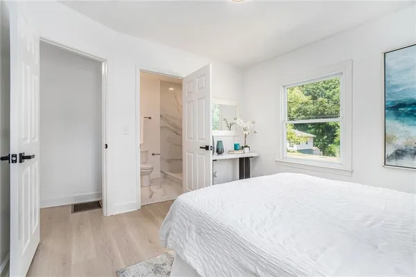 a spacious bedroom with a bed and a window