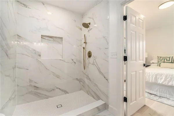 a bathroom with a bathtub and shower