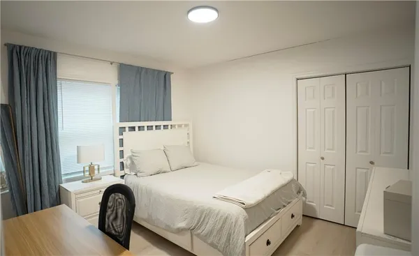 a bedroom with a bed and a window