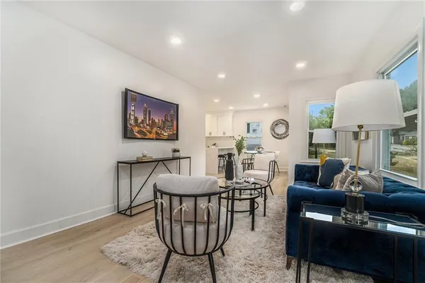 a living room with furniture a rug and a lamp