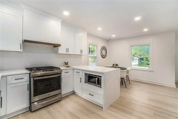 a kitchen with a stove top oven sink and cabinets