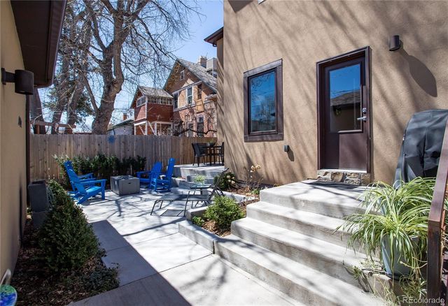 a view of backyard of house with outdoor seating